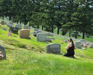 Saint Casimir Cemetery walk - Kaliyah posting a grave photo.